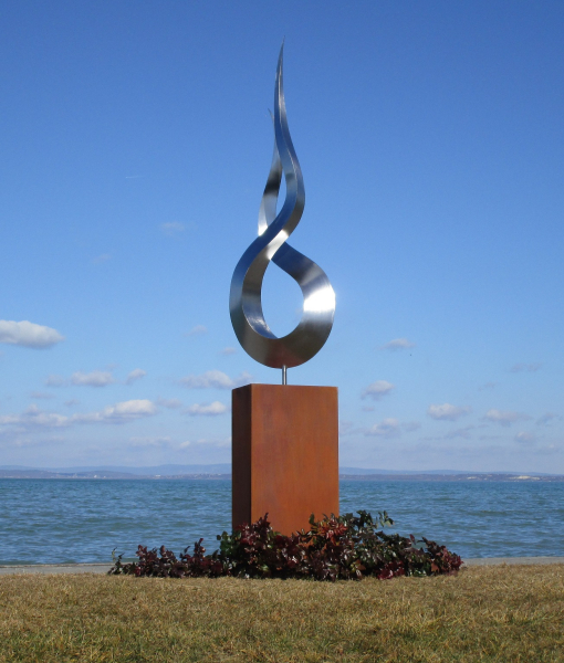 Big stainless steel garden artwork on rusty column